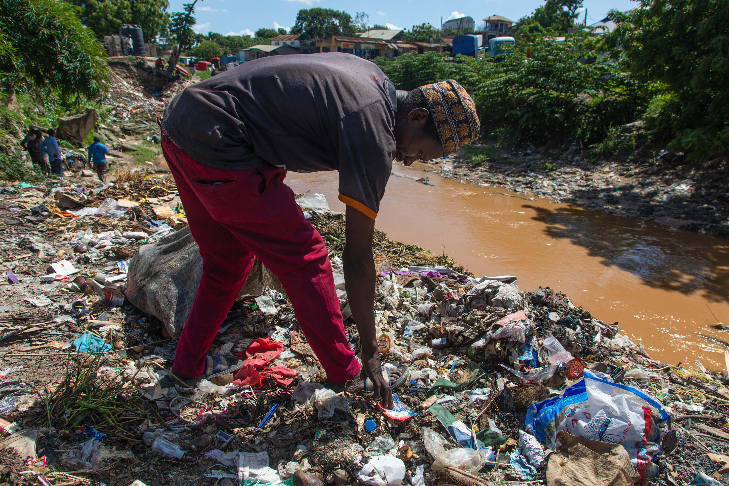 A waste picker in Tanzania on a mountain of plastic pollution 1 Daniel Msirikale Tearfund